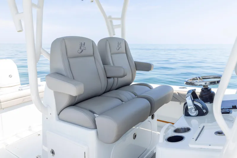 Slide: The Image of 2018 Yellowfin 32 Offshore boat with gray seats on open sea. - 34