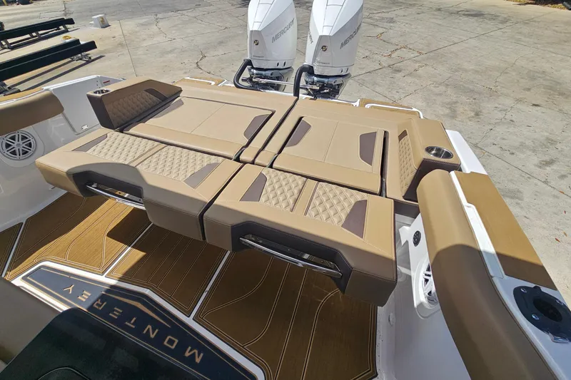 Slide: The Image of 2026 Monterey Elite 30 OB boat with luxurious tan seating and dual Mercury outboard engines. - 11