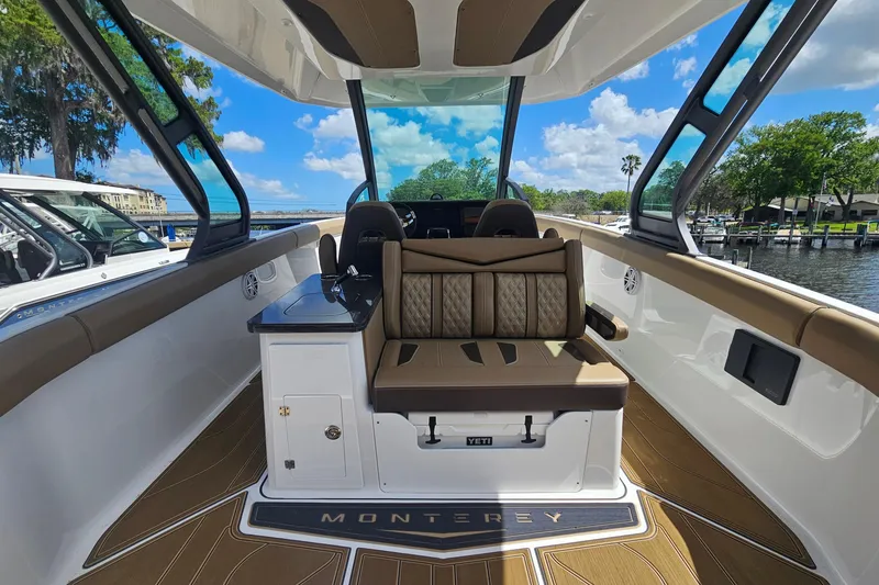 Slide: The Image of 2026 Monterey Elite 30 OB boat interior with luxurious seating and sleek design. - 12