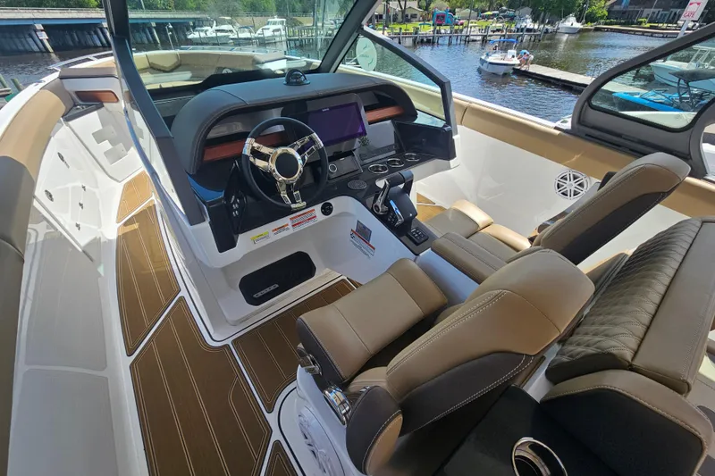 Slide: The Image of Interior of 2026 Monterey Elite 30 OB boat with modern dashboard and seating. - 15