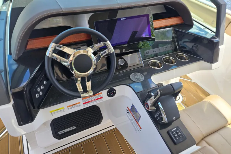 Slide: The Image of 2026 Monterey Elite 30 OB boat dashboard with steering wheel and control panel. - 16