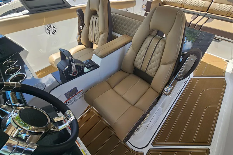 Slide: The Image of Luxurious interior of 2026 Monterey Elite 30 OB boat with plush seating and modern controls. - 17