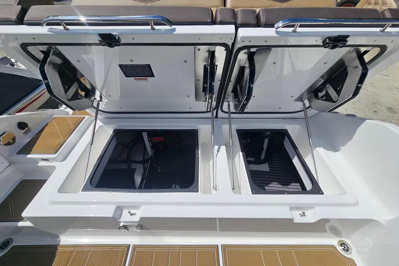 Slide: The Image of Open storage compartments on a 2026 Monterey Elite 30 OB boat deck. - 18