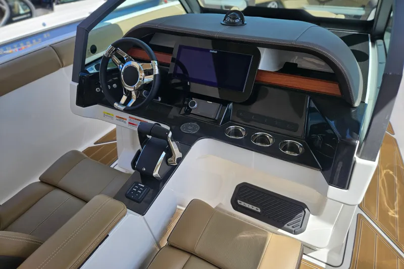 Slide: The Image of Interior cockpit of 2026 Monterey Elite 30 OB boat with modern steering and controls. - 19
