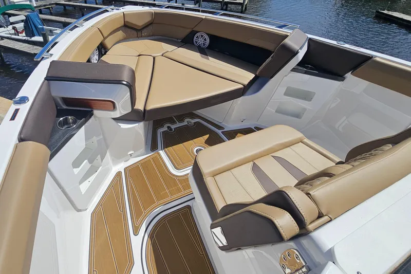 Slide: The Image of Luxurious seating on 2026 Monterey Elite 30 OB boat with tan upholstery and wood accents. - 20