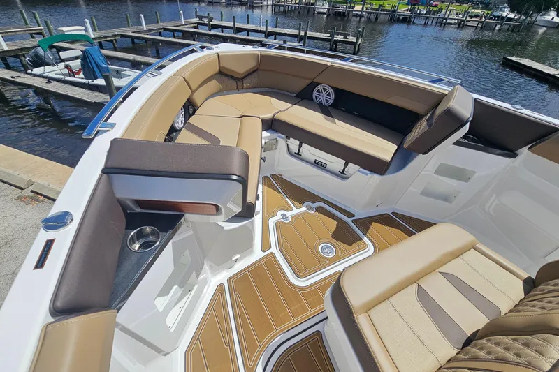 Slide: The Image of Luxurious interior of 2026 Monterey Elite 30 OB boat with tan seating and wood accents. - 21