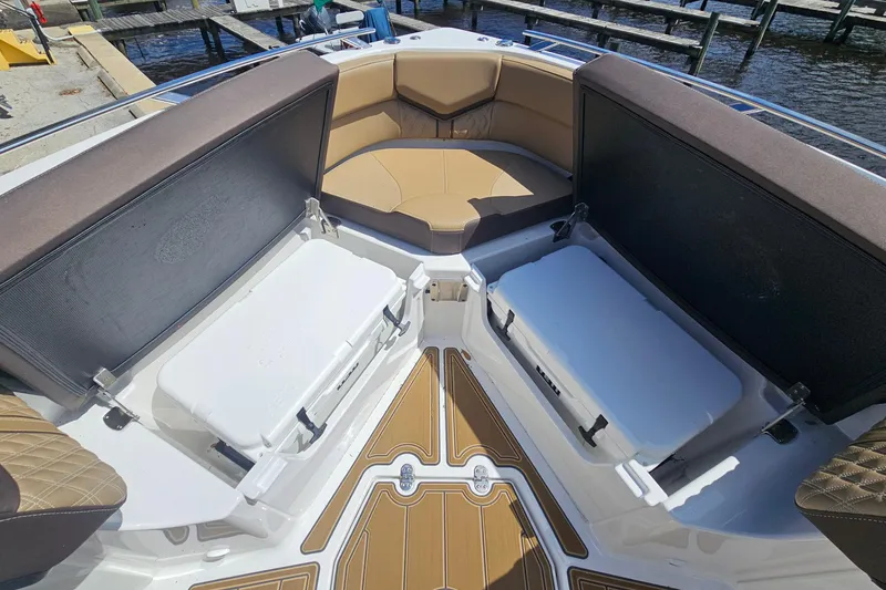 Slide: The Image of 2026 Monterey Elite 30 OB boat interior with open storage compartments and cushioned seating. - 22