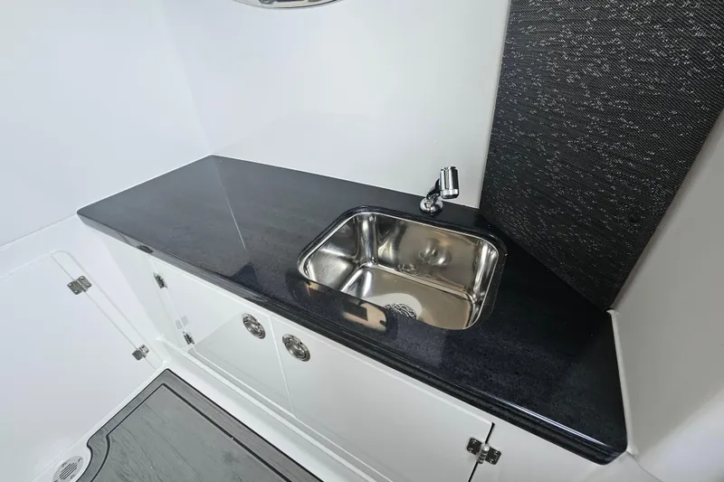 Slide: The Image of Luxury sink area in 2026 Monterey Elite 30 OB boat interior. - 27