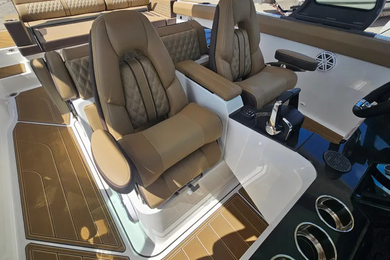 Slide: The Image of Luxurious seating on 2026 Monterey Elite 30 OB boat with brown leather upholstery. - 28