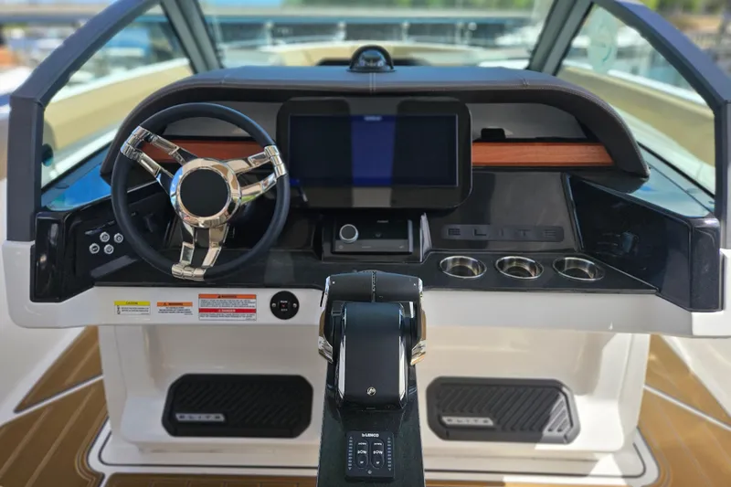 Slide: The Image of Cockpit of 2026 Monterey Elite 30 OB boat with modern steering and controls. - 29