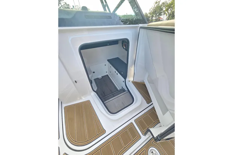 Slide: The Image of Interior cabin view of 2026 Monterey Elite 30 OB boat with wood-pattern flooring. - 30