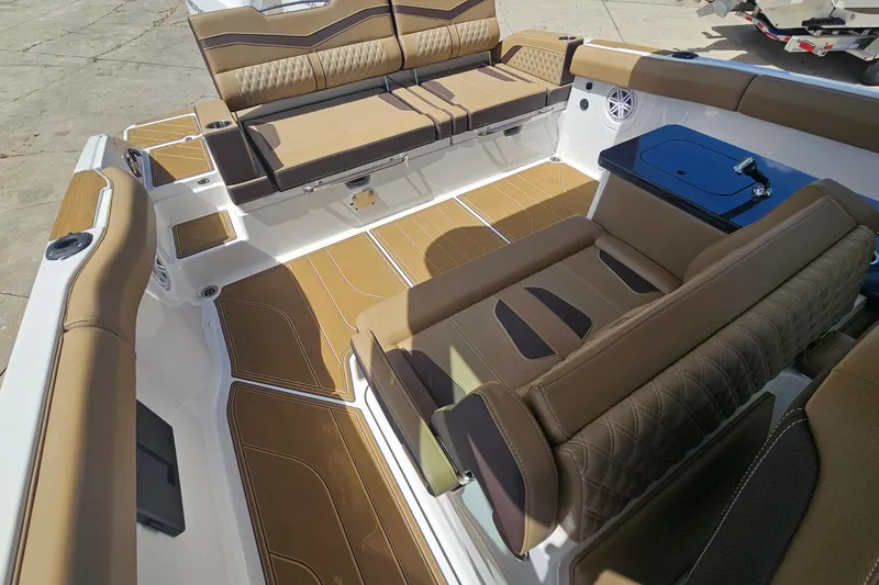 Slide: The Image of Luxurious interior of 2026 Monterey Elite 30 OB boat with tan seating and sleek design. - 9