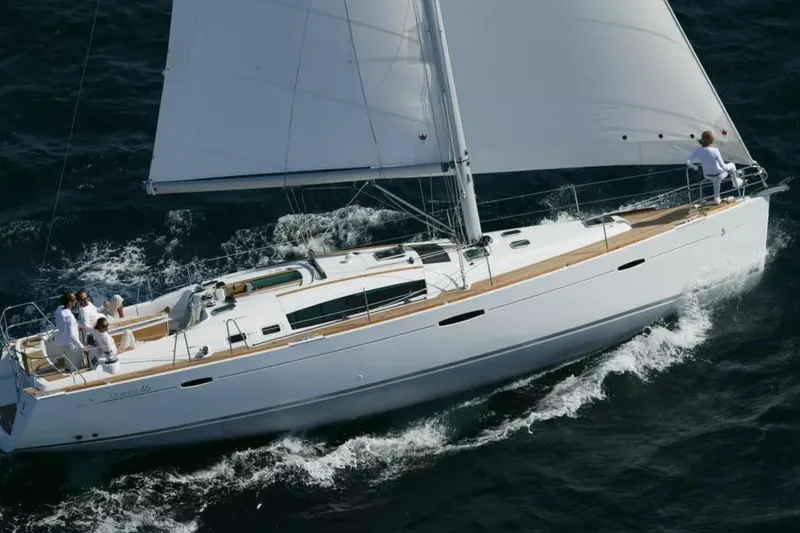 The Image of 2007 Beneteau Oceanis 46 sailing yacht on open water with crew onboard. - 0