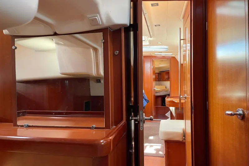 Slide: The Image of Interior of 2007 Beneteau Oceanis 46 yacht, featuring elegant wood finishes and spacious layout. - 25