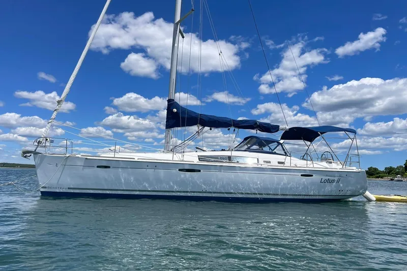 The Image of 2007 Beneteau Oceanis 46 sailboat on water under blue sky with clouds. - 1