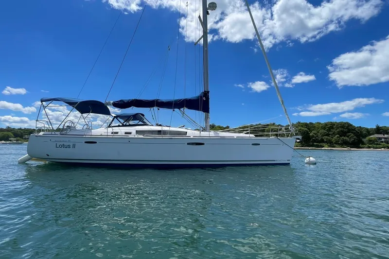 Slide: The Image of 2007 Beneteau Oceanis 46 sailboat anchored on calm water under a clear blue sky. - 40