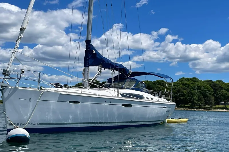 Slide: The Image of Sailboat Beneteau Oceanis 46, 2007 model, anchored on a sunny day with blue skies. - 36