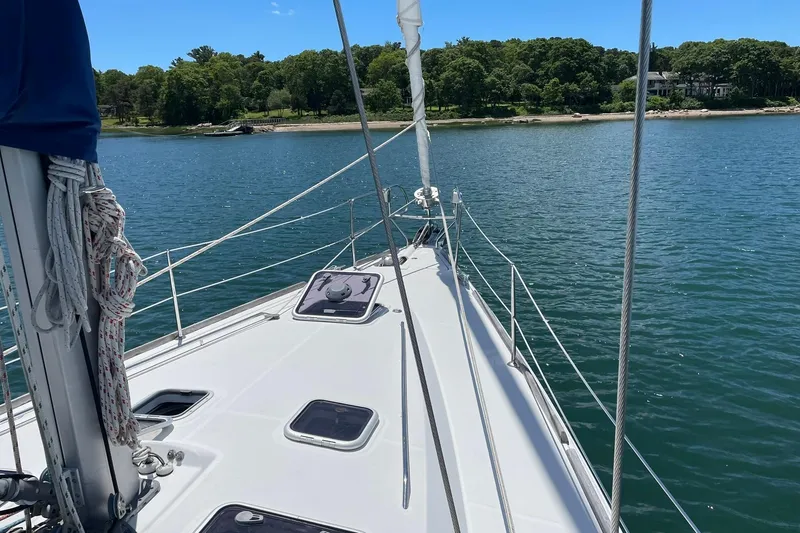 Slide: The Image of Sailing on a 2007 Beneteau Oceanis 46, calm waters, lush shoreline in view. - 42