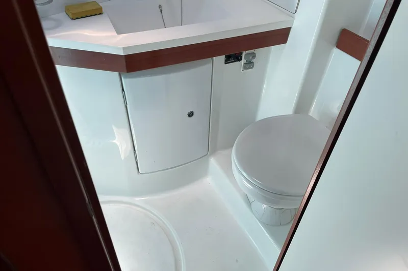 Slide: The Image of Bathroom interior of 2007 Beneteau Oceanis 46 yacht, featuring a compact toilet and sink. - 15