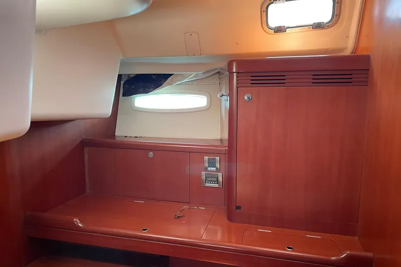 Slide: The Image of Interior of 2007 Beneteau Oceanis 46 yacht with wooden cabinetry and porthole window. - 19