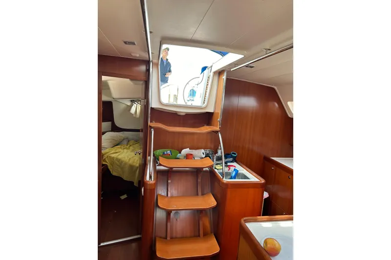 Slide: The Image of Interior of 2007 Beneteau Oceanis 46 sailboat with wooden cabinetry and cozy cabin. - 12