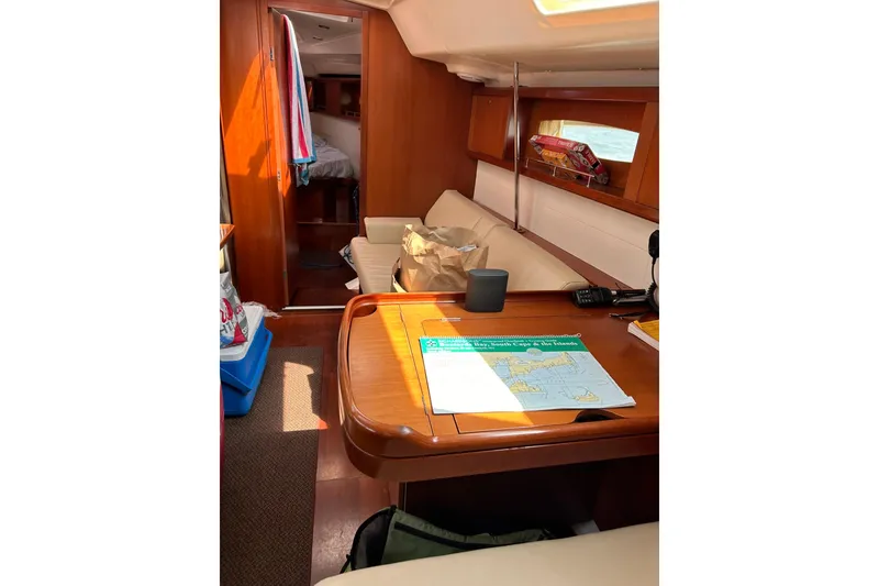 Slide: The Image of Interior of 2007 Beneteau Oceanis 46 sailboat with navigation table and seating area. - 7