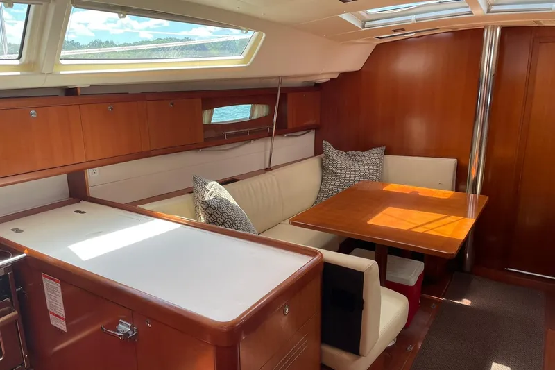 Slide: The Image of Interior of 2007 Beneteau Oceanis 46 sailboat with cozy seating and wooden finishes. - 22