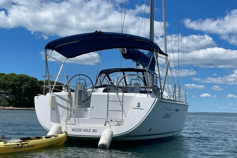 Slide: The Image of Beneteau Oceanis 46 sailboat, 2007 model, anchored in Woods Hole, MA, with a kayak nearby. - 33