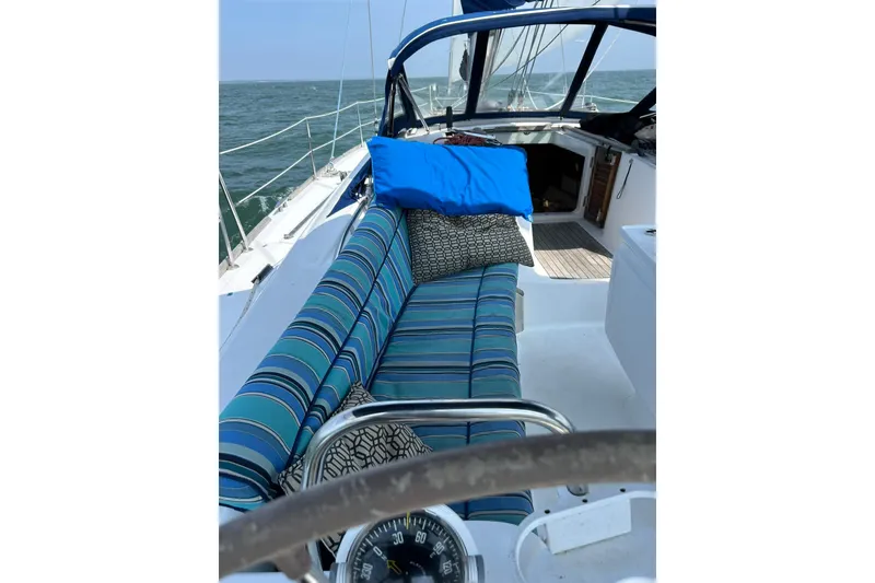 Slide: The Image of Cockpit of 2007 Beneteau Oceanis 46 sailboat with striped seating and nautical decor. - 9