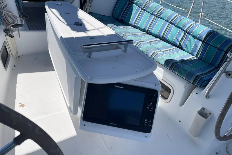 Slide: The Image of Cockpit of 2007 Beneteau Oceanis 46 with striped seating and navigation equipment. - 23