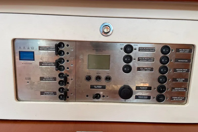Slide: The Image of Control panel of a 2007 Beneteau Oceanis 46 sailboat, featuring various switches and indicators. - 37