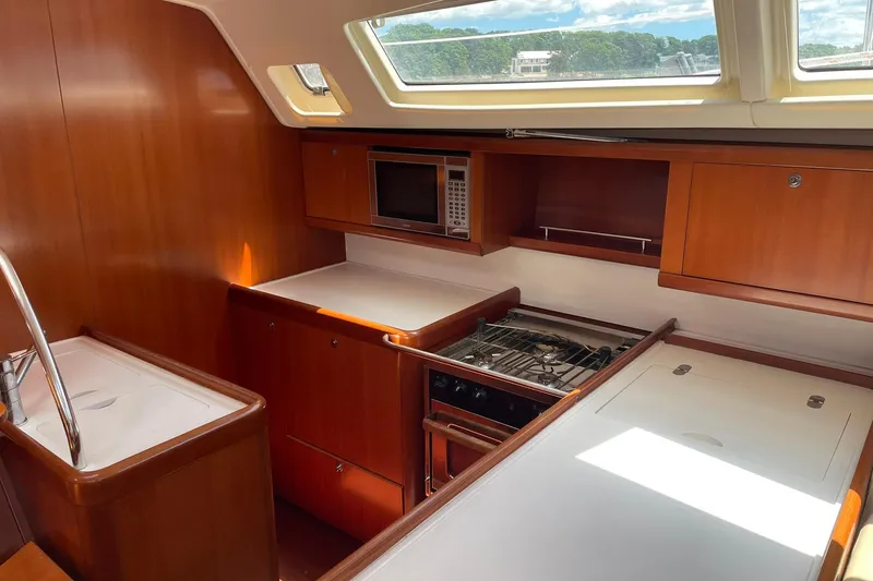 Slide: The Image of Interior of 2007 Beneteau Oceanis 46 yacht kitchen with wood finish and modern appliances. - 18