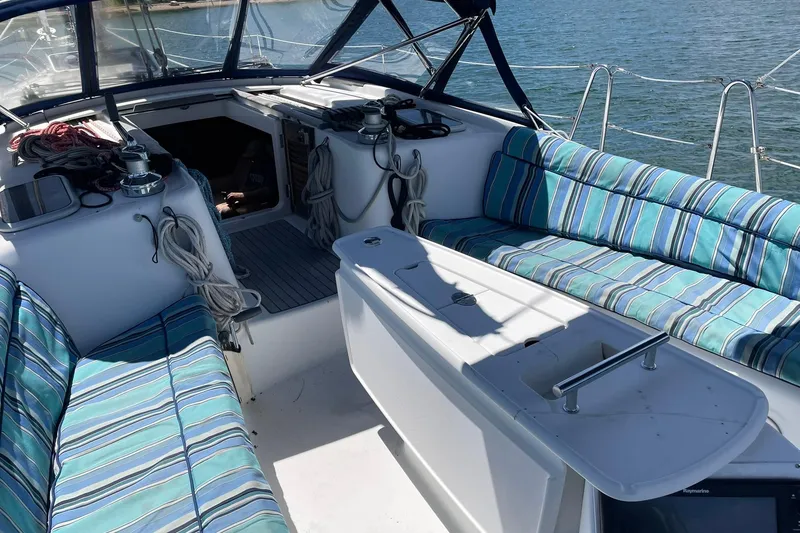 Slide: The Image of Cockpit of 2007 Beneteau Oceanis 46 sailboat with striped seating and nautical equipment. - 44