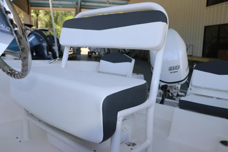Slide: The Image of 2026 Robalo R160 Center Console boat interior with seating and Yamaha 90 engine. - 17