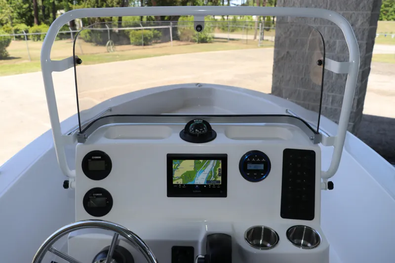 Slide: The Image of 2026 Robalo R160 Center Console boat dashboard with navigation system and steering wheel. - 18