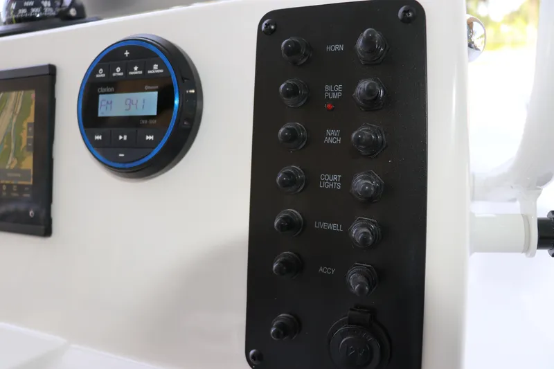 Slide: The Image of 2026 Robalo R160 Center Console dashboard with control panel and radio display. - 21