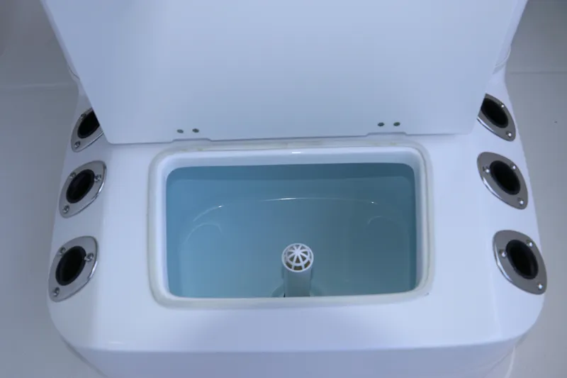 Slide: The Image of Livewell compartment on 2026 Robalo R160 Center Console boat, featuring multiple rod holders. - 25