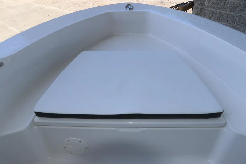 Slide: The Image of 2026 Robalo R160 Center Console boat's bow seating area with cushion. - 26