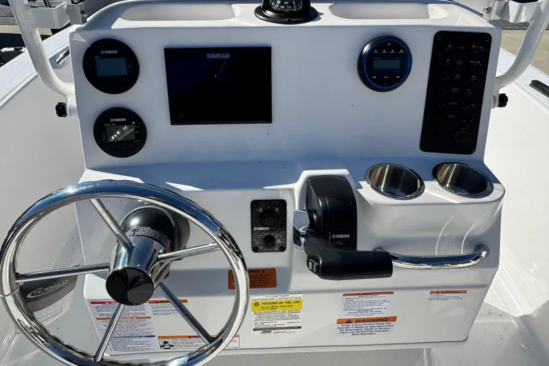 Slide: The Image of 2026 Robalo R160 Center Console dashboard with steering wheel and controls. - 5