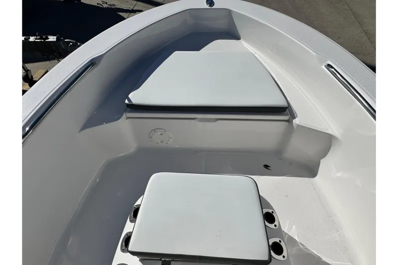 Slide: The Image of 2026 Robalo R160 Center Console boat interior with cushioned seating and storage. - 7