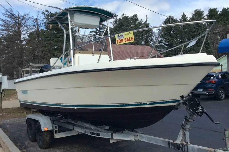 The Image of 1992 Pursuit 2150 Center Console boat on trailer, for sale sign visible. - 0