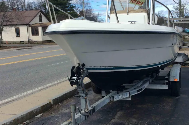 Slide: The Image of 1992 Pursuit 2150 Center Console boat on trailer, parked roadside, with "For Sale" sign. - 1