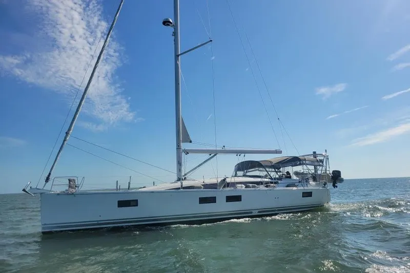 The Image of 2018 Jeanneau 51 sailboat cruising on open water under a clear blue sky. - 0