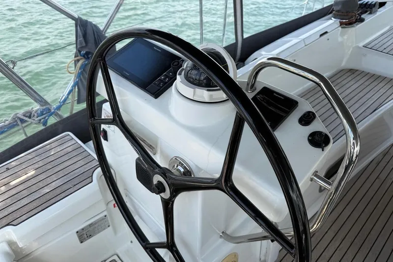 Slide: The Image of Steering wheel and controls of a 2018 Jeanneau 51 yacht on the water. - 18