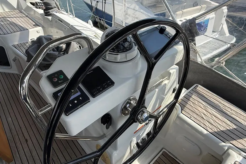 Slide: The Image of Steering wheel and controls of a 2018 Jeanneau 51 yacht, featuring a sleek design. - 20