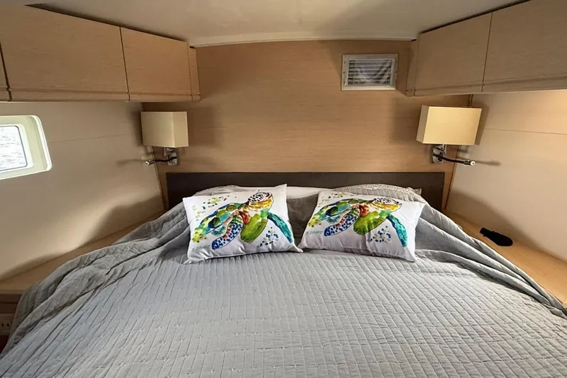 Slide: The Image of Cozy bedroom in 2018 Jeanneau 51 yacht with turtle-themed pillows and modern decor. - 24