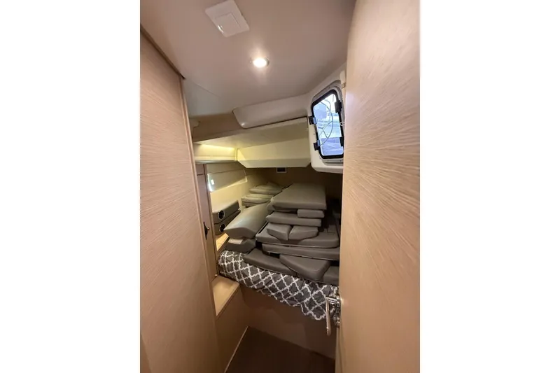 Slide: The Image of Interior cabin of 2018 Jeanneau 51 yacht with stacked cushions and window. - 26