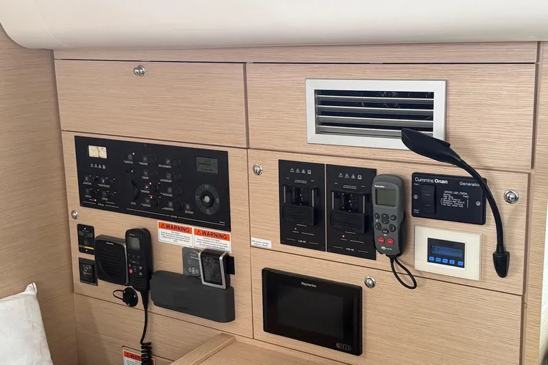 Slide: The Image of Control panel of a 2018 Jeanneau 51 yacht, featuring various electronic systems and displays. - 28