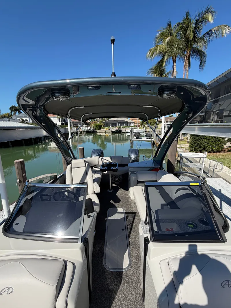 Slide: The Image of 2021 Avalon Excalibur Twin Elite Pontoon with windshield, docked at marina. - 10