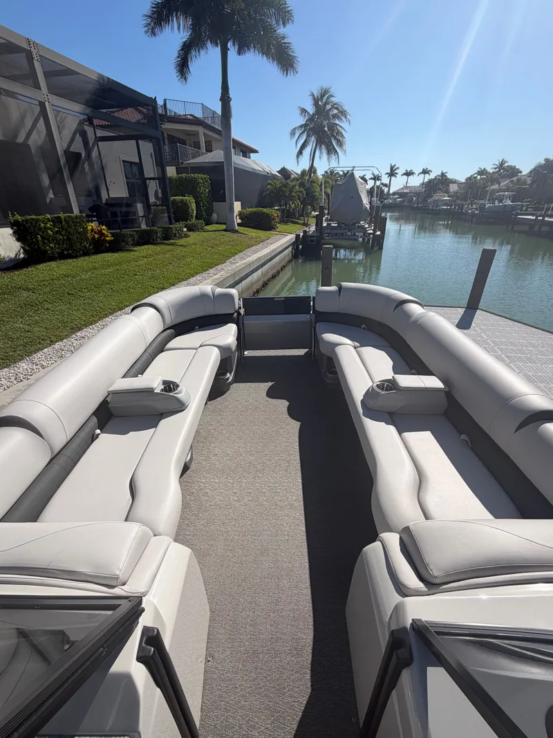 Slide: The Image of 2021 Avalon Excalibur Pontoon with luxurious interior by the water. - 3